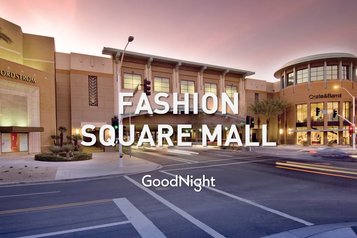 The vibrant, palm-lined entrance to Scottsdale Fashion Square, featuring the recognizable Nordstrom and Crate & Barrel storefronts, buzzes with activity. Shoppers and diners move through a lively, upscale environment, emphasizing access to premier shopping and dining just minutes away.